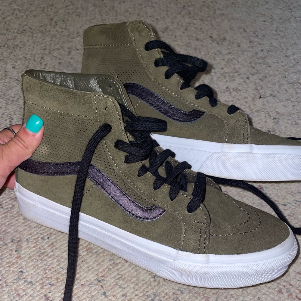 Woman’s dark green high top vans